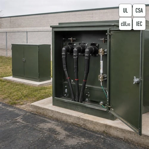 info-1-1 Open primary compartment of a loop feed pad-mounted transformer showing separable elbow connectors and a bayonet fuse holder